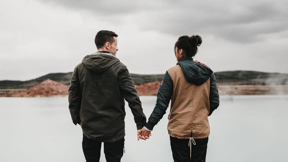 couple standing together holding hands