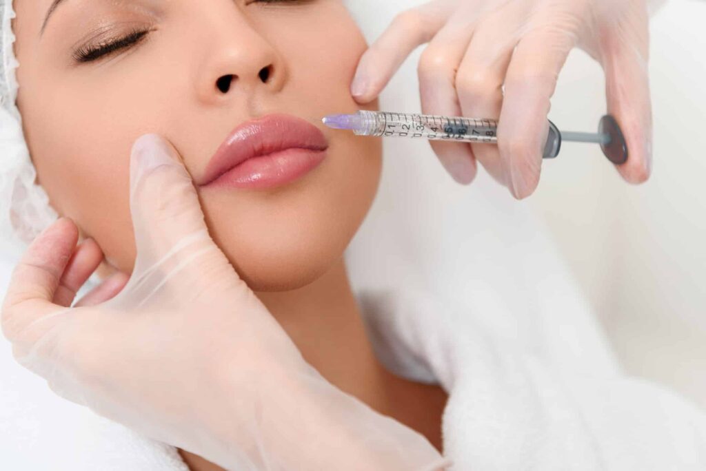 Juvederm Filler​, image of a young woman receiving a Juvederm injection in her upper lip.