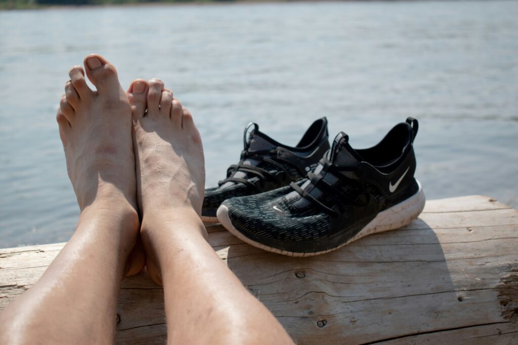 Alt text: Arthritis Weather Index, image of a man’s feet and sneakers with a body of water in the background.