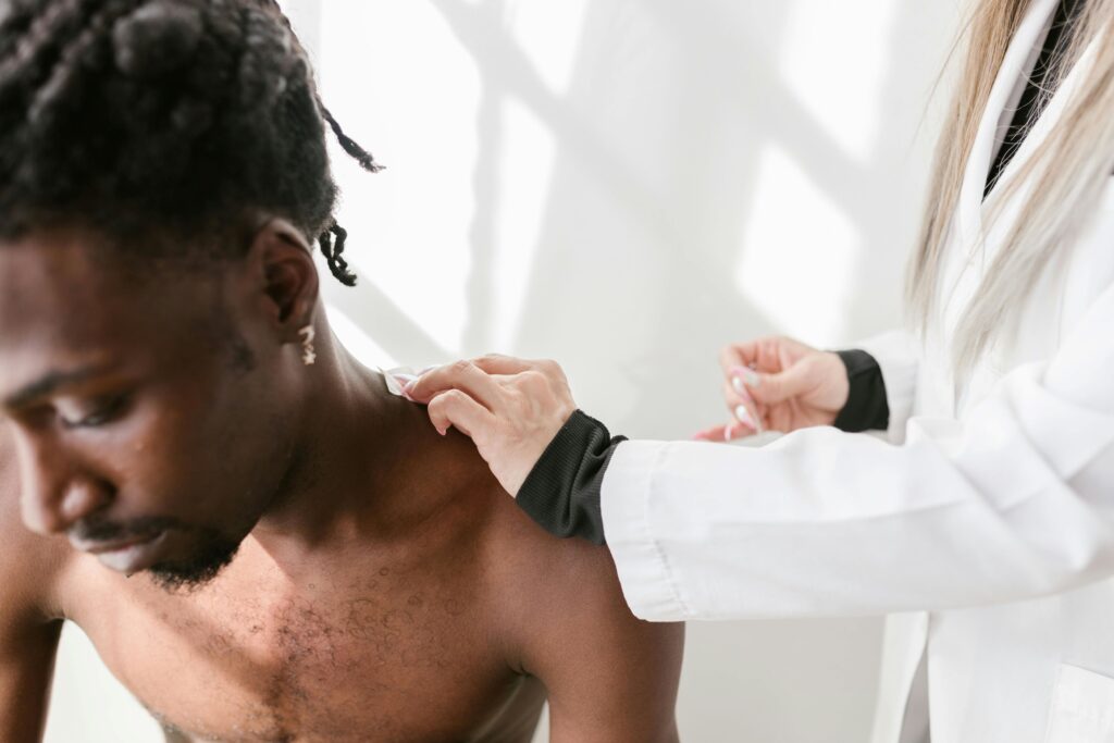 cortisone shot didn't work, Image of a male patient about to receive a shoulder injection by a female doctor.