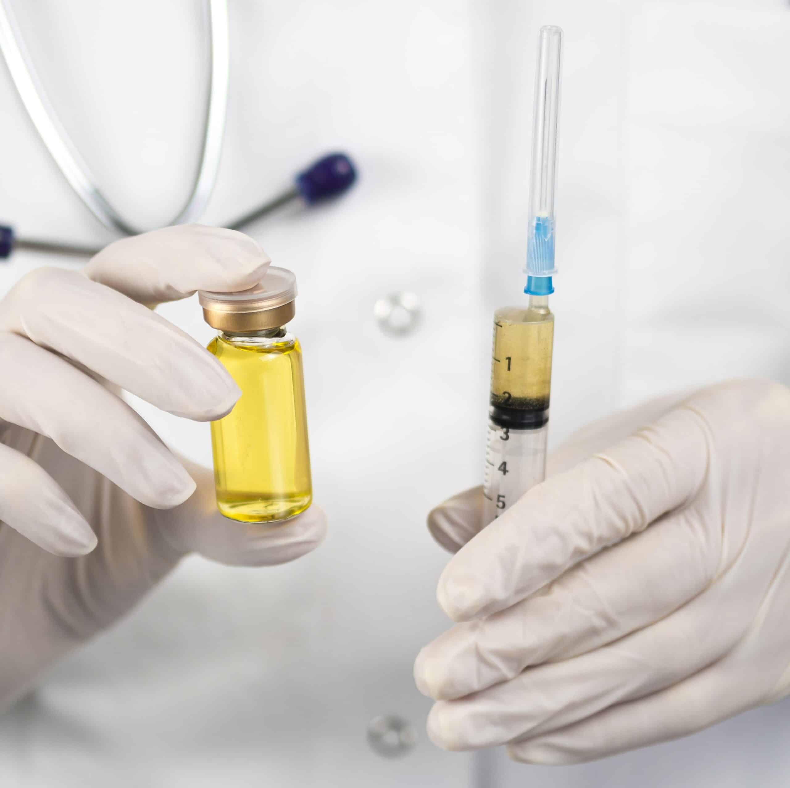 Orthopedic stem cell therapy, image of a doctor holding a vial and an injection needle filled with stem cell fluid.