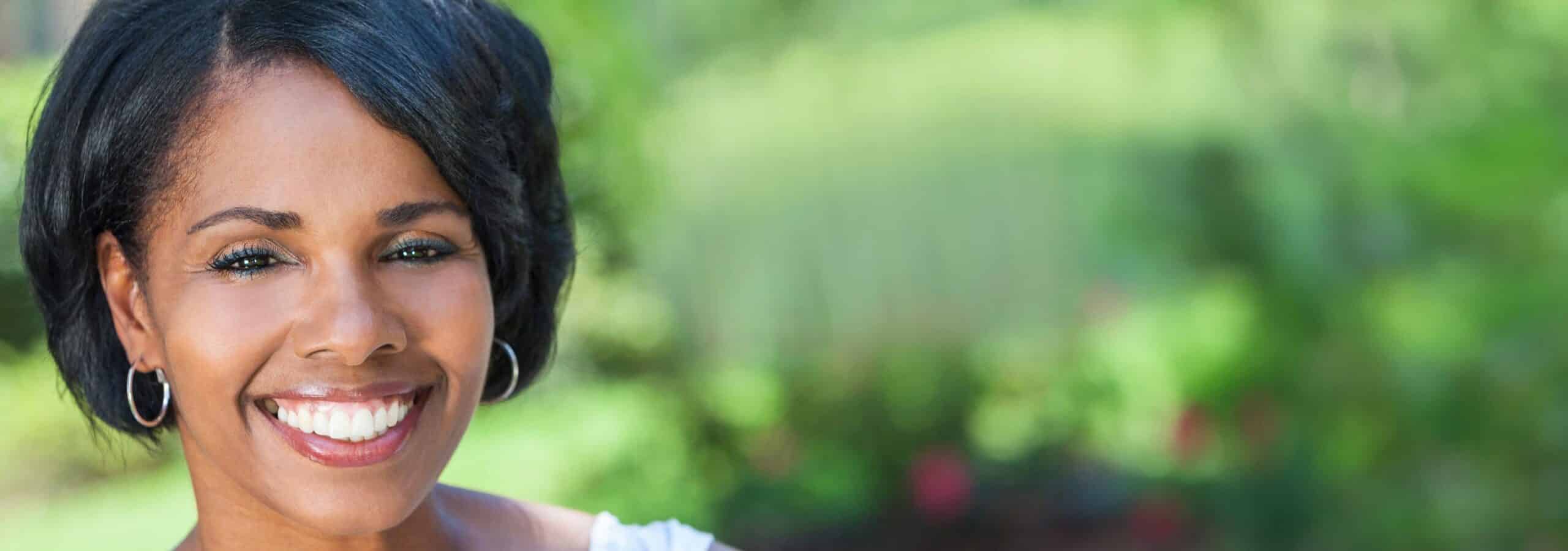 Microneedling with PRP, image of a woman with beautiful skin smiling.